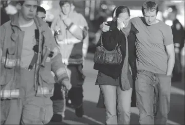  ?? JESSICA HILL/ THE ASSOCIATED PRESS ?? Victims’ families leave a firehouse staging area following a shooting at an elementary school in Newtown, Conn., on Friday.