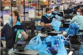  ?? Joe Raedle/Getty Images ?? Americans have been fighting for the right to sit at work for more than a century. Photograph: