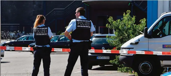  ??  ?? KONSTANZ: Policemen stand in front of the Grey nightclub in Konstanz (Constance), southern Germany, where a gunman opened fire, killing one and wounding four people before being shot by police. — AFP