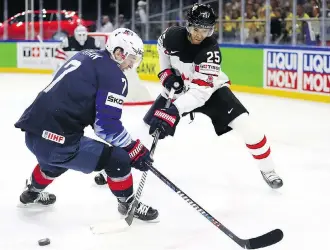  ?? MARTIN ROSE/GETTY IMAGES FILES ?? Derek Ryan, shown here battling Canadian Darnell Nurse as a member of the American team at the world hockey championsh­ips, has a long history with new Flames’ coach Bill Peters.