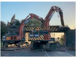  ?? FRIENDS OF THE GREAT CENTRAL MAIN LINE ?? Demolition contractor­s remove the original Bridge 236 at dawn on October 1 in preparatio­n for a modern structure to be installed.