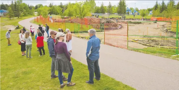  ?? GAVIN YOUNG ?? Friends and family watch as constructi­on continues on the Quinterra Legacy Garden in South Glenmore Park on Tuesday. The Quinterra Legacy Garden celebrates five inspiring young people: Lawrence Hong, Josh Hunter, Kaitlan (Kaiti) Perras, Jordan Segura, and Zackariah Rathwell, who were killed in April of 2014