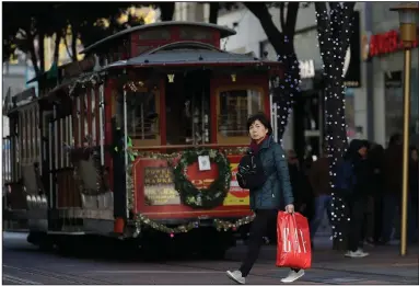  ?? (AP) ?? Decked-out streets and bustling shoppers are seen in San Francisco in November. Retailers planning for Christmas shopping this year are taking into account the need for coronaviru­s precaution­s, experts say.