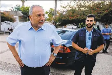  ?? Menahem Kahana AFP/Getty Images ?? ISRAELI politician Avigdor Lieberman, left, campaigns in Nahal Oz. The leader of the right-wing, nationalis­t Yisrael Beiteinu party retains a preternatu­ral ability to infuriate Prime Minister Benjamin Netanyahu.