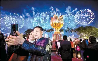  ?? South China Morning Post ?? Tourists take a photo of fireworks during Lunar New Year on Feb. 11 in Hong Kong. The city last year welcomed 34 million visitors, 17 million of whom stayed overnight.