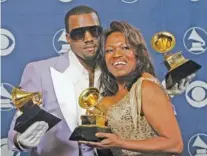  ?? AP PHOTO/REED SAXON ?? Kanye West and his mother, Donda, hold his three awards backstage at the 48th Annual Grammy Awards in Los Angeles in 2006.