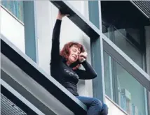  ?? Photo: REUTERS ?? Too much: An employee of the Workers Housing Organisati­on threatens to jump from her Athens office yesterday because her wages had been cut and she and her husband were threatened with layoffs. The woman was later led to safety.