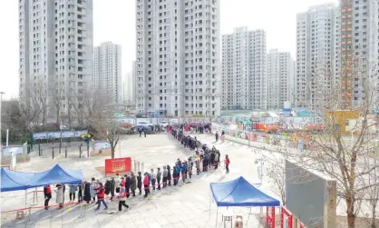  ?? Photograph: Reuters ?? People line up for Covid testing in the Chinese port city of Tianjin, which is testing its population of 14 million.