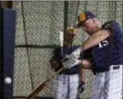  ?? MORRY GASH — THE ASSOCIATED PRESS ?? Milwaukee Brewers’ Erik Kratz hits during a spring training baseball workout Thursday in Phoenix.