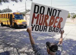  ?? LM Otero / Associated Press ?? David Trujillo protests abortions in front of a building in Dallas where a clinic provides the procedure. A federal judge has ordered Texas to suspend its recently enacted abortion ban.