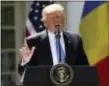  ?? ANDREW HARNIK —THE ASSOCIATED PRESS ?? President Donald Trump speaks during a news conference with Romanian President Klaus Werner Iohannis, in the Rose Garden at the White House Friday in Washington. the president is trying to change the subject from scandal back to his promise to make...