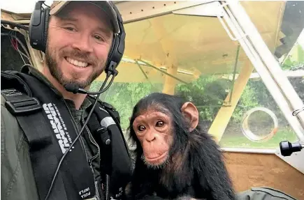  ??  ?? Anthony Caere sets off for the Lwiro Primates rehabilita­tion centre with orhpaned chimpanzee Mussa - one of many he has helped rescue.