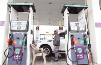  ?? — Reuters ?? A worker walks at a petrol station in Riyadh, Saudi Arabia.