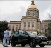  ?? Planned Georgia factory. NATRICE MILLER/NATRICE.MILLER@AJC.COM ?? A Rivian electric vehicle sits outside the Georgia state Capitol on March 1 for the first Rivian Day. Rivian CEO R.J. Scaringe says the company’s long-term success is staked on its