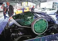  ??  ?? Future look People view a Toyota Future Mobility Concept car at the 2014 Los Angeles Auto Show. Driverless technology can be the “second driver” on- board, Inagaki says.