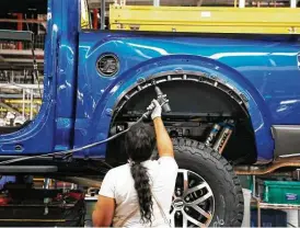  ?? Carlos Osorio / Associated Press file ?? An F-150 truck is assembled at the Ford Rouge plant in Dearborn, Mich., in 2018. In addition to tires and auto parts, rubber is critical for gloves and packaging tapes.