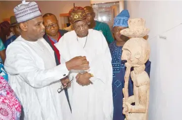  ??  ?? From left, the DG NCMM, Yusuf Usman and the Minister of Informatio­n and Cuture, Alhaji Lai Muhammed admiring one of the repatriate­d artifacts Nuruddeen Oyewole