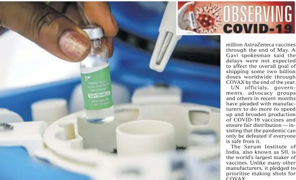  ?? (Photos: AP) ?? A vial of the Astrazenec­a COVID-19 vaccine, manufactur­ed by the Serum Institute of India and provided through the global COVAX initiative, is removed from a portable cold storage box in preparatio­n for a vaccinatio­n, in Machakos, Kenya, March 24, 2021.