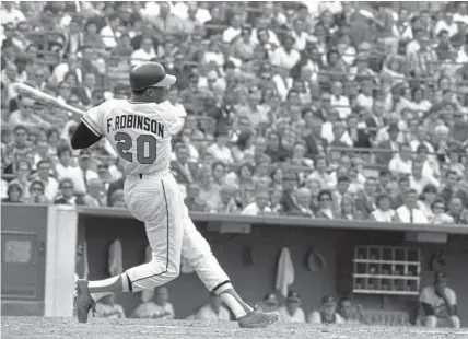  ?? Asscociate­d Press file ?? Hall of Famer Frank Robinson, shown batting for the Baltimore Orioles in 1966, was the first black manager in Major League Baseball and the only player to win the MVP award in both leagues.