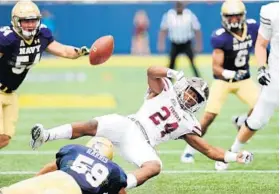  ?? PAUL W. GILLESPIE/BALTIMORE SUN MEDIA GROUP ?? Navy’s Ryan Harris tackles Fordham’s Jihaad Pretlow as he fumbles in the season opener Sept. 3. The play led to a touchdown by the Mids as Navy went on to win, 52-16.