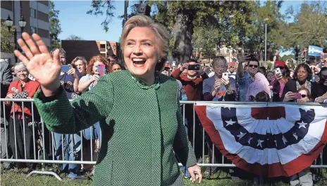  ?? ROBYN BECK, AFP/GETTY IMAGES ?? Hillary Clinton waves to supporters in Raleigh on Sunday. She’s ending her campaign with a direct appeal to Republican­s.