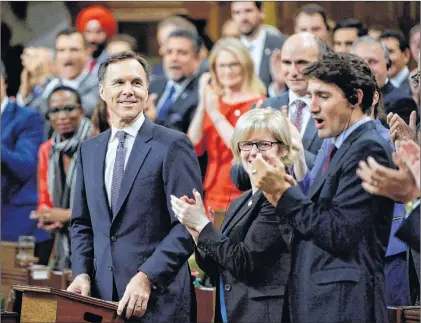  ?? CP PHOTO ?? Finance Minister Bill Morneau receives applause before delivering his fall economic statement in the House of Commons in Ottawa Tuesday.