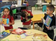  ?? TAWANA ROBERTS — THE NEWS-HERALD ?? Elm Street Elementary kindergart­ners elated after receiving new books from the Cleveland Kids’ Book Bank in partnershi­p with Painesvill­e Schools Family Resource Center.