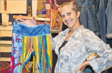  ?? DAVE STEWART/THE GUARDIAN ?? Angie MacDonald, co-owner of eco*spirit in the Confederat­ion Court Mall in Charlottet­own, displays a pair of pants made from 100 per cent recycled plastic bottles.