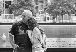  ?? BRYAN R. SMITH/AP 2015 ?? The tradition of relatives reading names of Sept. 11 victims in person has been suspended amid the pandemic. Above, relatives of one of the victims attend a ceremony in New York.