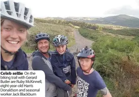  ??  ?? Celeb selfie On the biking trail with Gerard Butler are Ruby McKinnell, eight-year-old Harris Donaldson and seasonal worker Jack Blackburn