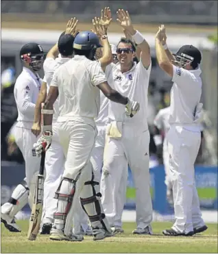  ?? Picture: AP. ?? Graeme Swann (second right) celebrates the wicket of Sri Lankan batsman Suraj Randiv (left) with his team-mates.