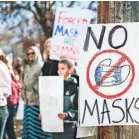  ?? HUNTER D’ANTUONO/ FLATHEAD BEACON VIA AP ?? Demonstrat­ors protest mask requiremen­ts on March 9 outside Flathead High School in Kalispell, Mont.