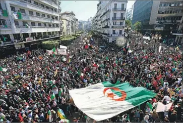  ?? Toufik Doudou Associated Press ?? PROTESTERS fill the streets of the capital, Algiers, demanding the ouster of President Abdelaziz Bouteflika and other top officials. Bouteflika, 82, has agreed not to run again but wants to postpone the election.