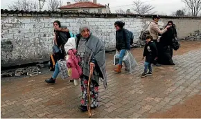  ?? AP ?? Migrants walk towards the Turkish-Greek border near Pazarkule, Edirne region, Turkey, after a suggestion earlier this year that border controls were to be loosened.