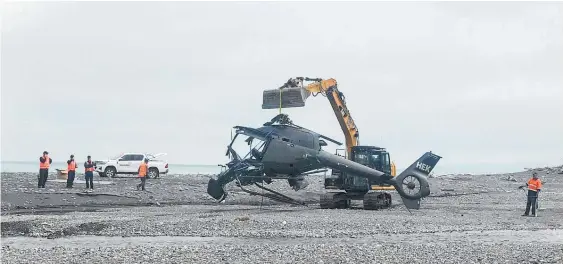  ?? Photo / Anna Leask ?? The wreckage of the helicopter is loaded onto a truck on the beach at the mouth of the Kekerengu River, near Kaikoura.