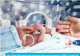  ?? — AFP ?? CALI: Diana Paola Angola who recovered of the novel coronaviru­s, COVID-19, caress her son Jefferson at the neonatal room in the Versalles Clinic, in Cali, Colombia.