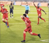  ?? Jessica Hill / Associated Press ?? Toronto FC’s Alejandro Pozuelo, front, celebrates his goal against the Philadelph­ia Union with teammates during an Oct. 3 game in East Hartford.