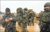  ?? Ohad Zwigenberg Associated Press ?? ISRAELI soldiers prepare to enter the Gaza Strip from a staging area in southern Israel on Wednesday.