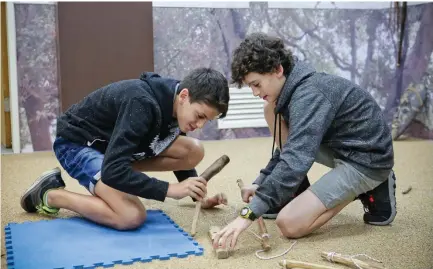  ??  ?? CHILDREN PARTICIPAT­E in the activity ‘Cavemen discover fire’ at the Kfar Saba Museum.