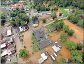  ?? Contribute­d RFCEMA / ?? A drone view of downtown Cave Spring on Thursday shows the extent of flooding from Little Cedar Creek.