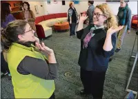  ?? DANA JENSEN/THE DAY ?? Emma Palzere-Rae, left, Ignite program manager for Thames River Inovation Place, and Susan Hackett of the Women’s Business Developmen­t Council, raise their hands Wednesday during an excercise, part of the monthly lunchtime session of “Improv for Scientists and Others Who Just Want to Have Fun” at BioCT Innovation Commons in Groton.