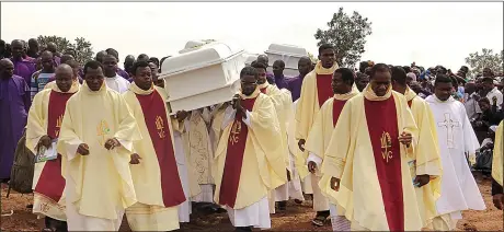  ??  ?? VICTIMS: Clergy carry the coffins of priests killed by Fulani militia in central Nigeria earlier this year