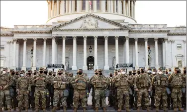  ?? (The New York Times/Jason Andrew) ?? National Guard troops, part of a large security force, muster Thursday outside the U.S. Capitol.