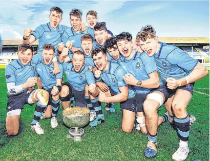 ?? RAMSEY CARDY/SPORTSFILE ?? The St Michael’s College team celebrate with the trophy after defeating Gonzaga during yesterday’s Leinster Schools Senior Cup final at the RDS Arena