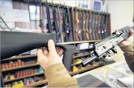  ?? George Frey Getty Images ?? A NEW POLL finds disagreeme­nt over firearm restrictio­ns, but one former gun owner believes devices such as “bump stocks,” as shown above, should be outlawed.