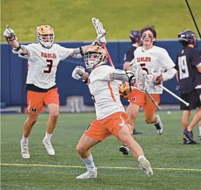  ?? KENNETH K. LAM/BALTIMORE SUN ?? McDonogh’s McCabe Millon, center, celebrates his game-winning overtime goal against Boys’ Latin in an MIAA A Conference semifinal Tuesday at Navy-Marine Corps Memorial Stadium.
