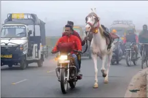  ?? NARINDO NANU/AFP ?? Indian commuters lead a horse on a road as they make their way through heavy smog in Amritsar yesterday.