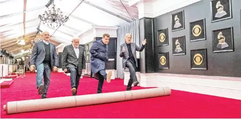 ??  ?? (Left to right) Jack Sussman from CBS, executive poducer of the 60th Annual Grammy Awards Ken Ehrlich, host Corden and Recording Academy President/CEO Neil Portnow participat­e in a ceremonial red carpet roll outside the Madison Square Garden in New...