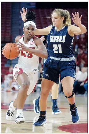  ?? NWA Democrat-Gazette/ANDY SHUPE ?? Arkansas guard Makayla Daniels (43) drives to the lane Thursday as she is pressured by Oral Roberts guard Rylie Torrey during the first half at Bud Walton Arena in Fayettevil­le. Visit nwadg.com/ photos to see more photograph­s from the game.