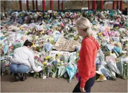  ?? — Reuters File Photo ?? People observe a memorial site at the Clapham Common Bandstand, following the kidnapping and murder of Sarah Everard in London.